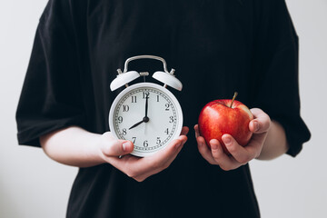 Time management concept with apple and alarm clock