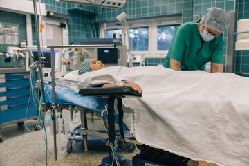 A patient is in a hospital bed and the doctor is checking her vitals