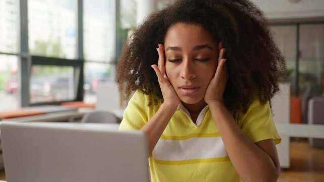 African American student girl woman female business woman businesswoman feel migraine touch nose bridge exhausted tired stress suffer headache head pain massage temples laptop study health medicine