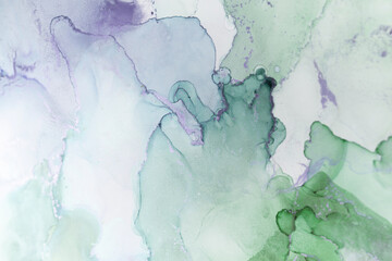 Abstract watercolor blending shades of green and lavender creates a soothing composition suitable...