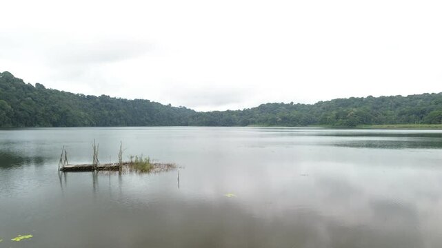 Low aerial rising shot overhead Tamblingan Lake within Buleleng Regency, Bali