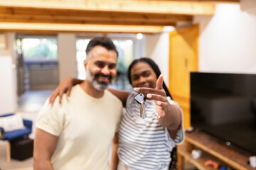 Couple celebrating new home with keys in hand