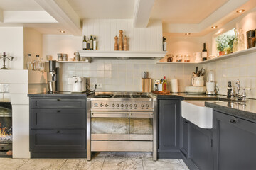 Modern kitchen with black cabinets and stainless steel appliances