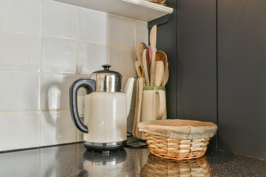 Modern kitchen countertop with utensils and electric kettle