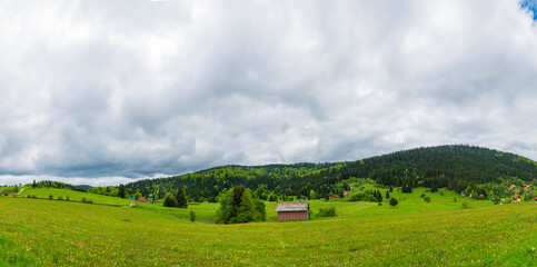 Fototapeta premium Small houses among green hills. Serbia