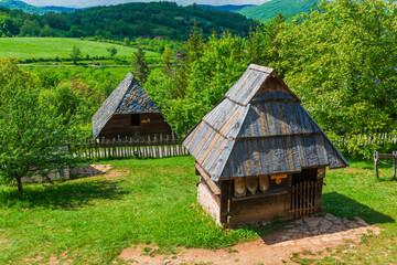 Old wooden houses in Serbian village. Rural landscape in summer