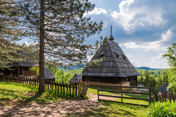 Old wooden houses in Serbian village. Rural landscape in summer