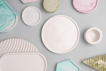 Plaster geometric shapes, trays on a gray background