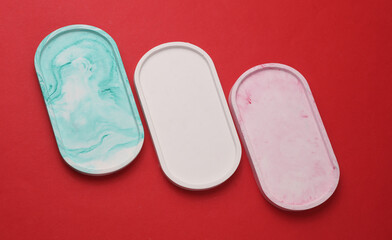 Oval plaster trays on a red background