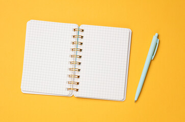 Open Notepad with pen on a blue background