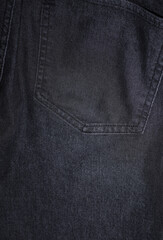 Back pocket of dark gray jeans