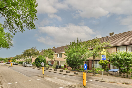 Suburban street with row houses and school zone sign