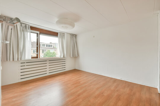 Empty modern room with natural light and hardwood floor