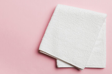 Top view of white towels with copy space on colored background