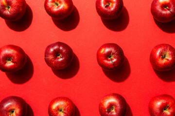 Many red apples on colored background, top view. Autumn pattern with fresh apple above view