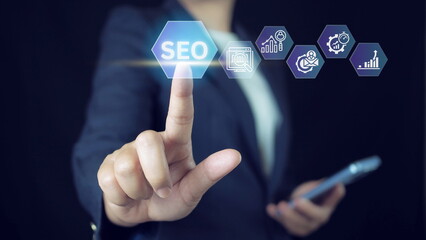 Businessman touching SEO icon on virtual screen for analyze SEO search engine optimization. Promote...