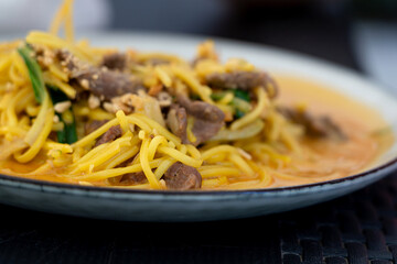 Chiang mai curry noodles, asian spicy egg pasta with meat, curried noodle soup Khao Soi or Khao Sawy, thai food