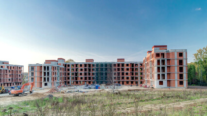 Fototapeta premium Construction site with buildings under construction and multi-storey residential homes timelapse hyperlapse.