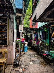 Metro Manila, Philippines - Aug 28, 2024: A narrow, cluttered passageway in a Metro Manila slum,...