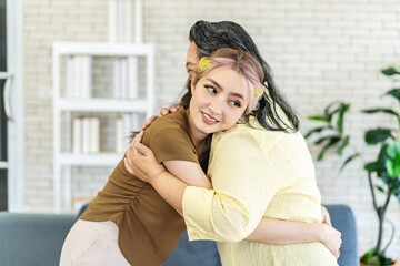 Happy asian senior mother and young daughter standing and hugging close up, smiling woman embracing older mum, spending leisure time together, two generations good relationship, fun