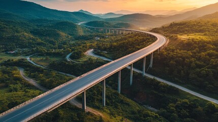 Obraz premium An overhead picture of a motorway bridge that connects towns at dusk, spanning a valley with verdant hills and forests as part of infrastructure development