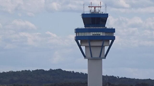 image control tower airport, perfectly backlit, iconic structure's central position against aviation architecture landmark silhouette air traffic control sunset airport operations