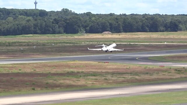 sleek unmarked private jet taking off from airport, exclusivity luxury private exclusive aircraft airport operations air travel private aviation takeoff flight runway