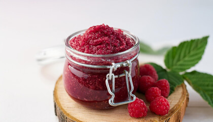 Jar of raspberry body scrub. Homemade cosmetics. Beauty product, organic ingredients. Close-up.