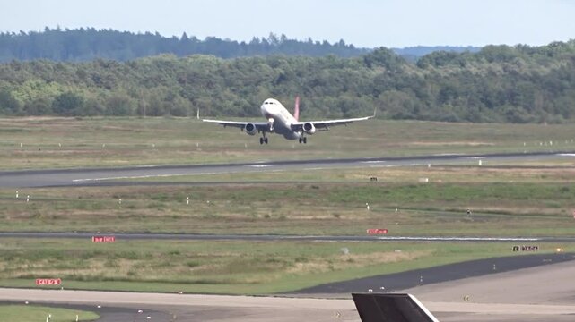 dynamic airplane performing go-around maneuver international airport sudden change flight path aircraft ascends back into sky after aviation flight maneuver runway airport operations aerial view