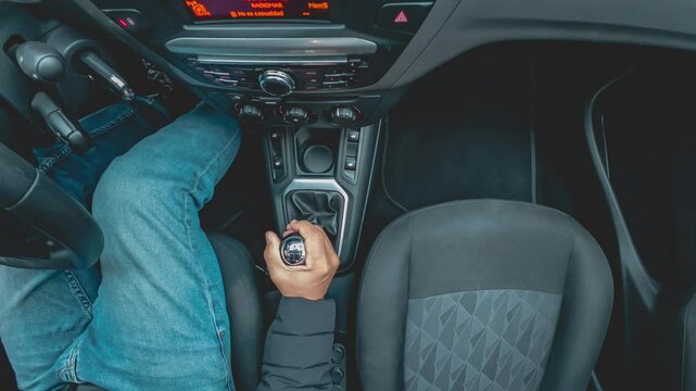 Man skillfully shifting gears in a modern manual transmission car