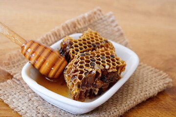 Honeycomb and dipper on wooden table