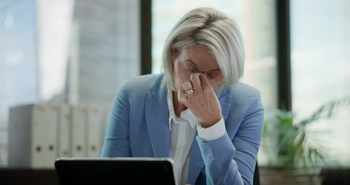 Mature business woman, laptop and headache for burnout, budget mistake and 404 glitch in office. Female accountant, computer and migraine pain for payroll problem, audit and poor connection.