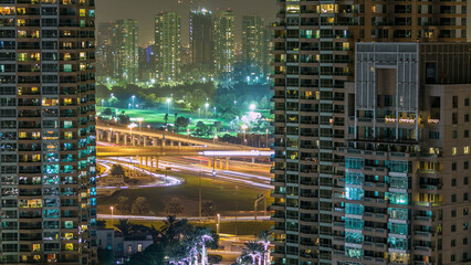 Golf field timelapse from top at night time with traffic on sheikh zayed road.