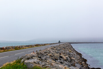 Eriskay causeway on a foggy day, Image shows the causeway connecting Eriskay to South Uist on a...