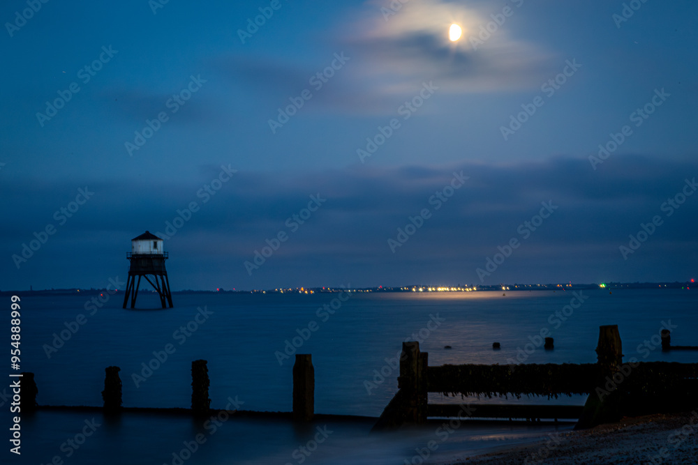 Wall mural Dovercourt lighthouse at night, Image shows the historic lighthouse along Dovercourt beach illuminated by the moon on a late evening with long exposure