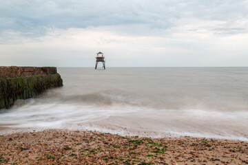 Lighthouse in the sea long exposure, Dovercourt lighthouse at high tide built in 1863 and discontinued in 1917 and restored in 1980 the lighthouse is still a iconic sight on a cloudy evening 