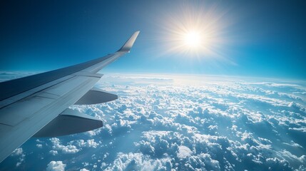 View from an airplane window showing the wing and bright sky