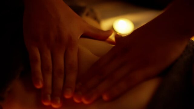 Masseuse performing relaxing stomach massage