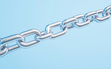 Obraz premium A close-up of a shiny metal chain against a soft blue background, symbolizing strength and connectivity in various contexts.