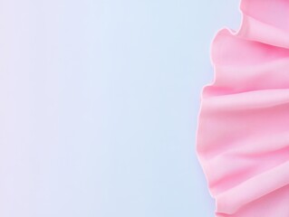 A close-up view of soft pink fabric draped elegantly against a light background, perfect for design and textile presentations.