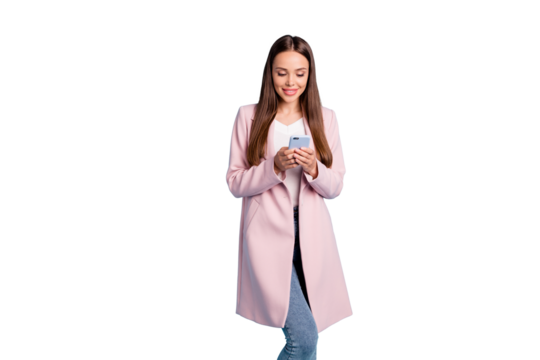 Portrait of cute concentrated lady using her cellphone reading news information wearing topcoat isolated over blue background