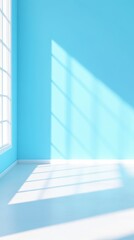 Obraz premium Bright blue wall with soft shadows creating a calm and serene atmosphere in a spacious room filled with natural light.