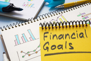 Notebook with financial goals on a table. Personal finance planning.