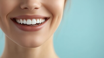 Fototapeta premium A close-up of a woman's radiant smile with perfectly white teeth, set against a smooth light blue background, symbolizing health and confidence.