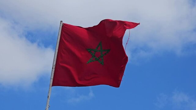 view of a Moroccan Flag waiving against blue sky - Kingdom of Morocco flag waving 