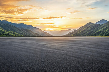 Empty asphalt road and beautiful mountain landscape under sunset background. High quality photo