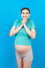 Young beautiful pregnant woman on isolated colored background celebrating surprised and amazed for success with arms raised and open eyes. Winner concept