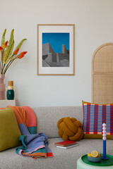 Modern living area with a light beige couch, accented by colorful geometric pillows, a soft throw,...