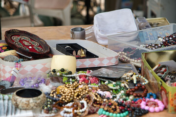 Jewelry and antique-looking items are showcased at the flea market in Autocine Mercadillo, Spain.