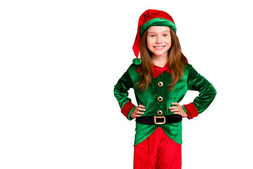 Portrait of lovely child elf fairy helper having toothy smile ready to help at night wearing green costume isolated over red background